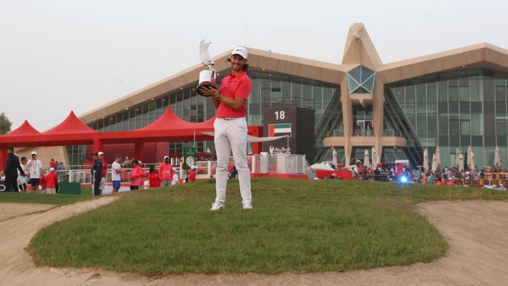Tommy Fleetwood with the Abu Dhabi HSBC Championship trophy 